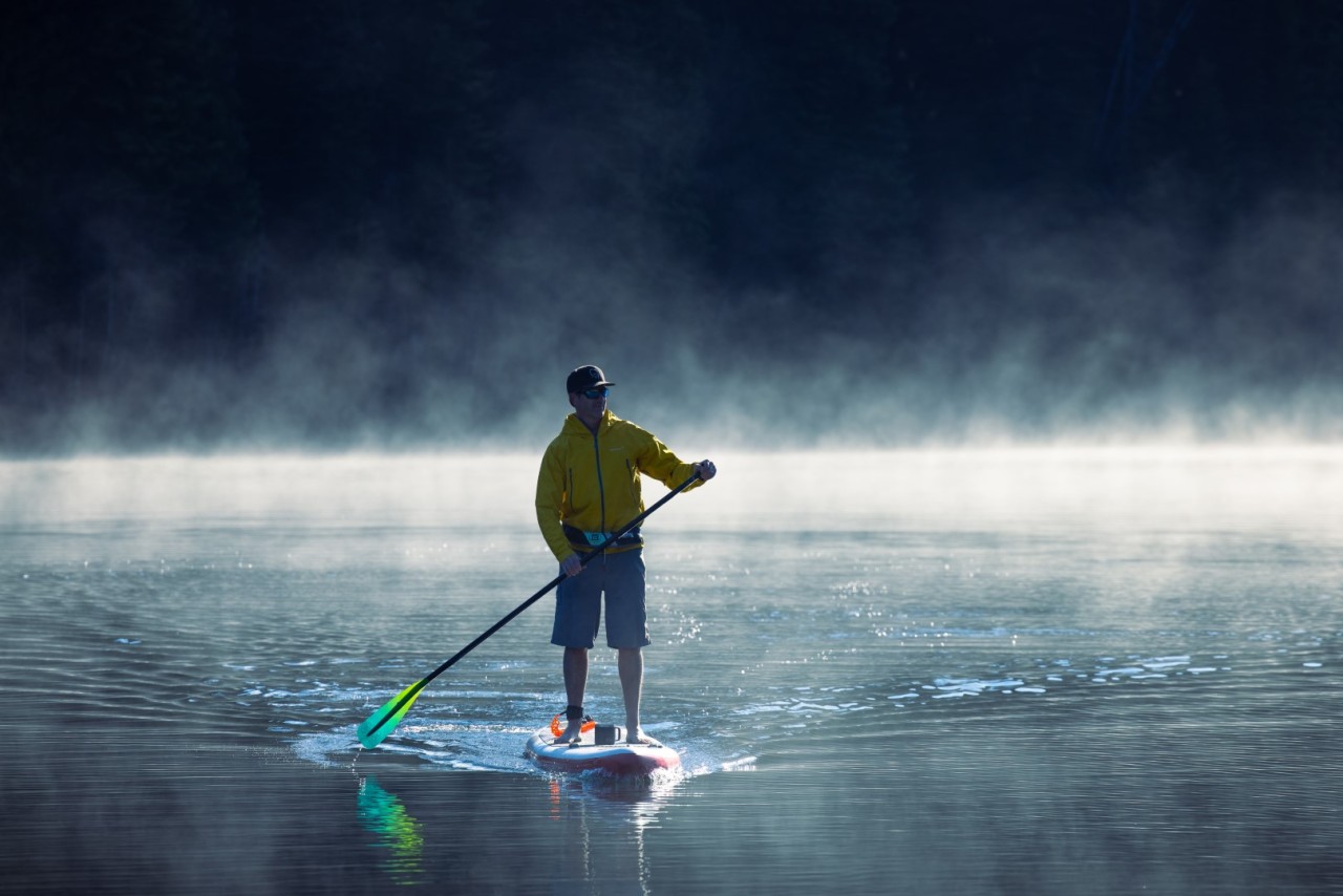 Man paddleboarding on Keefer Lake